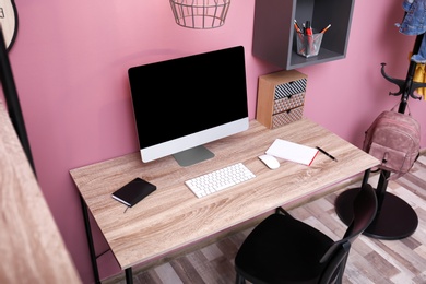 Photo of Comfortable workplace with computer on desk in home office