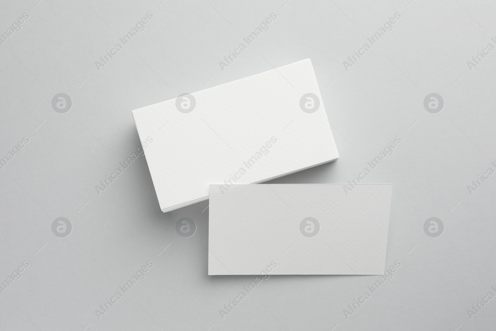 Photo of Blank business cards on light grey background, top view. Mockup for design