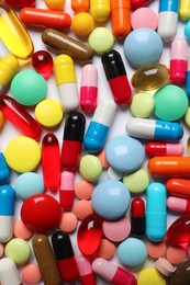 Lots of different colorful pills as background, top view