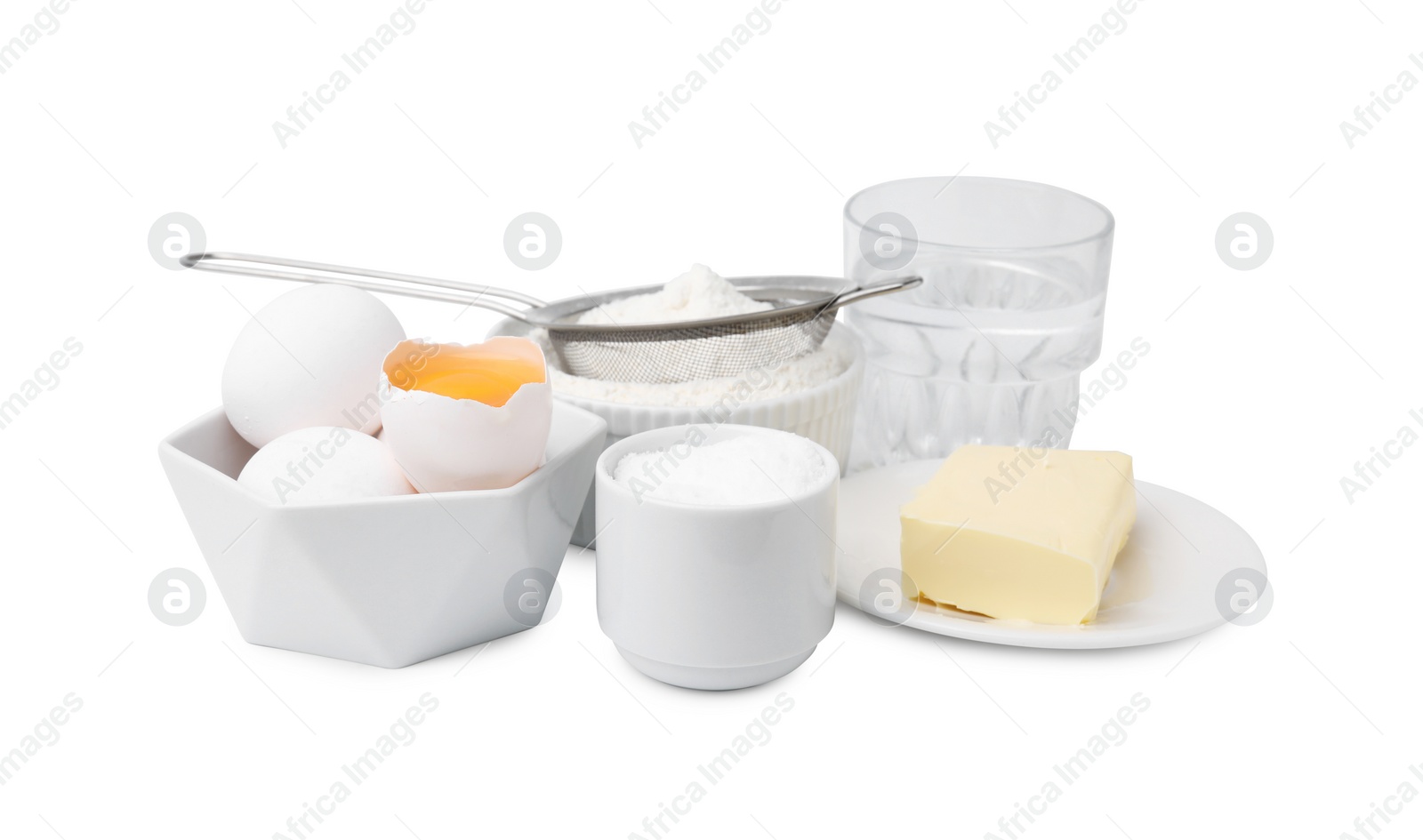 Photo of Eggs, butter, flour, salt and water isolated on white. Ingredients for puff pastry dough