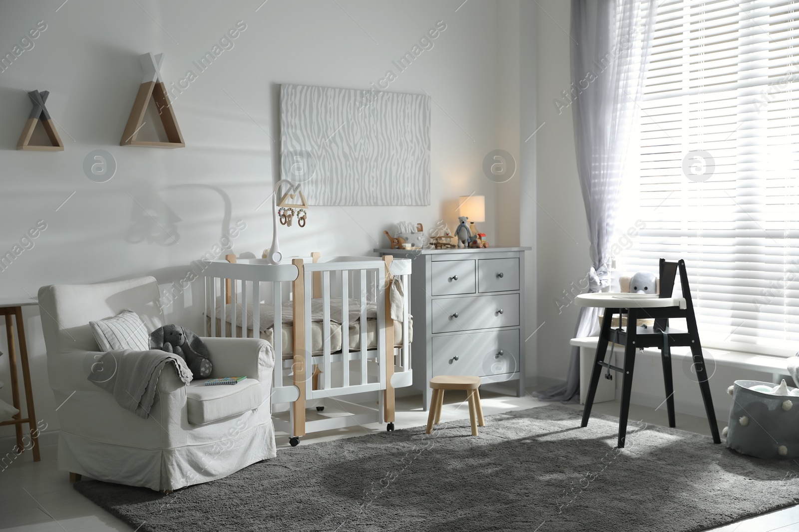 Photo of Baby room interior with crib and highchair. Idea for design