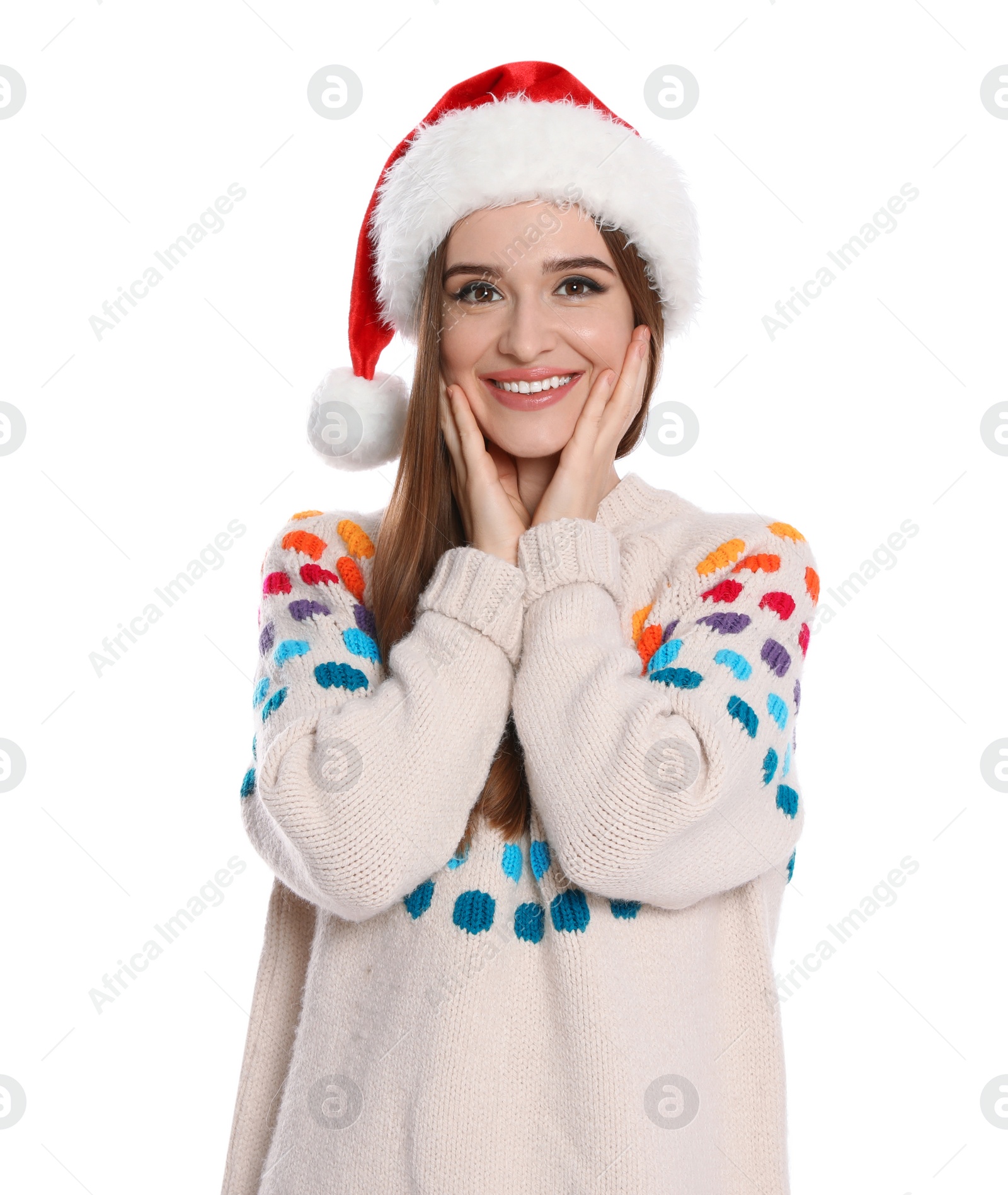 Photo of Happy young woman in sweater and Santa hat on white background. Christmas celebration