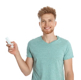 Photo of Young man with air conditioner remote on white background