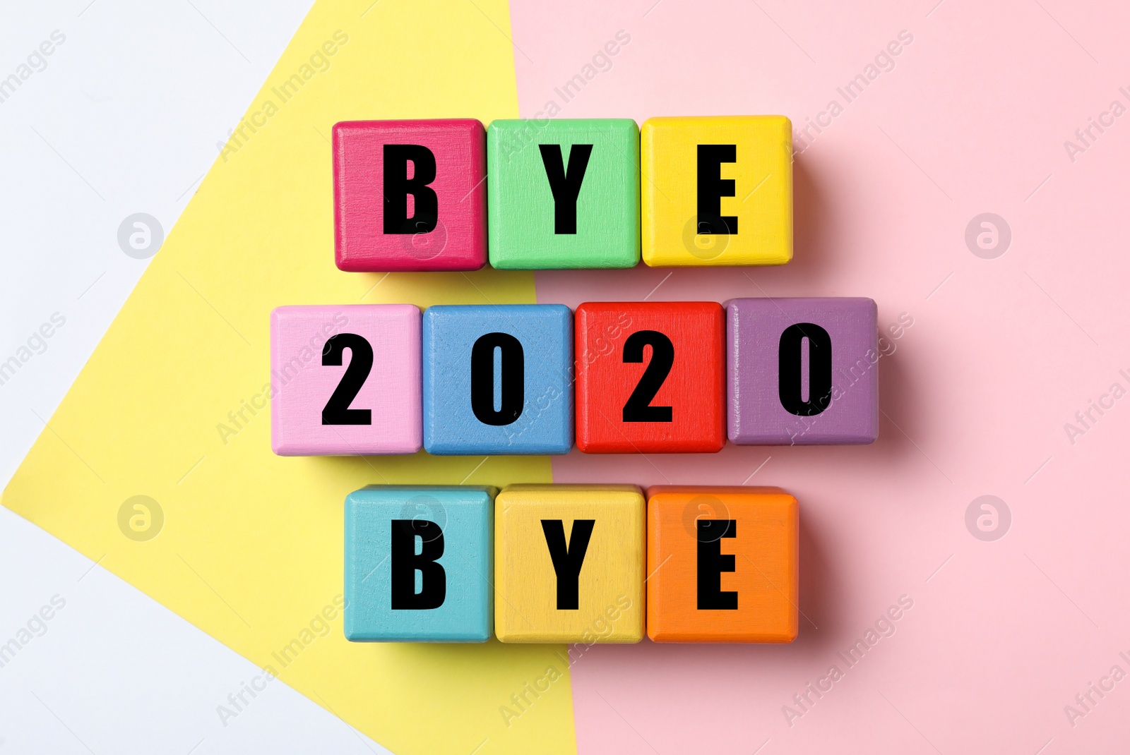 Photo of Cubes with phrase Bye 2020 Bye on color background, flat lay