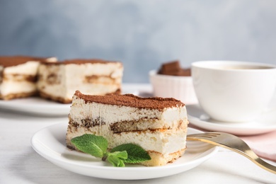 Tiramisu cake and drink served on table