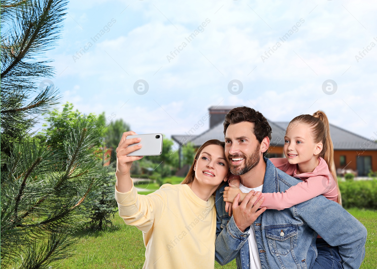 Image of Happy family with child taking selfie near house