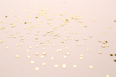 Photo of Confetti stars on pink background. Christmas celebration