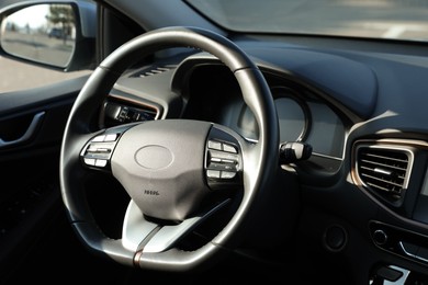 Black steering wheel and dashboard in modern car