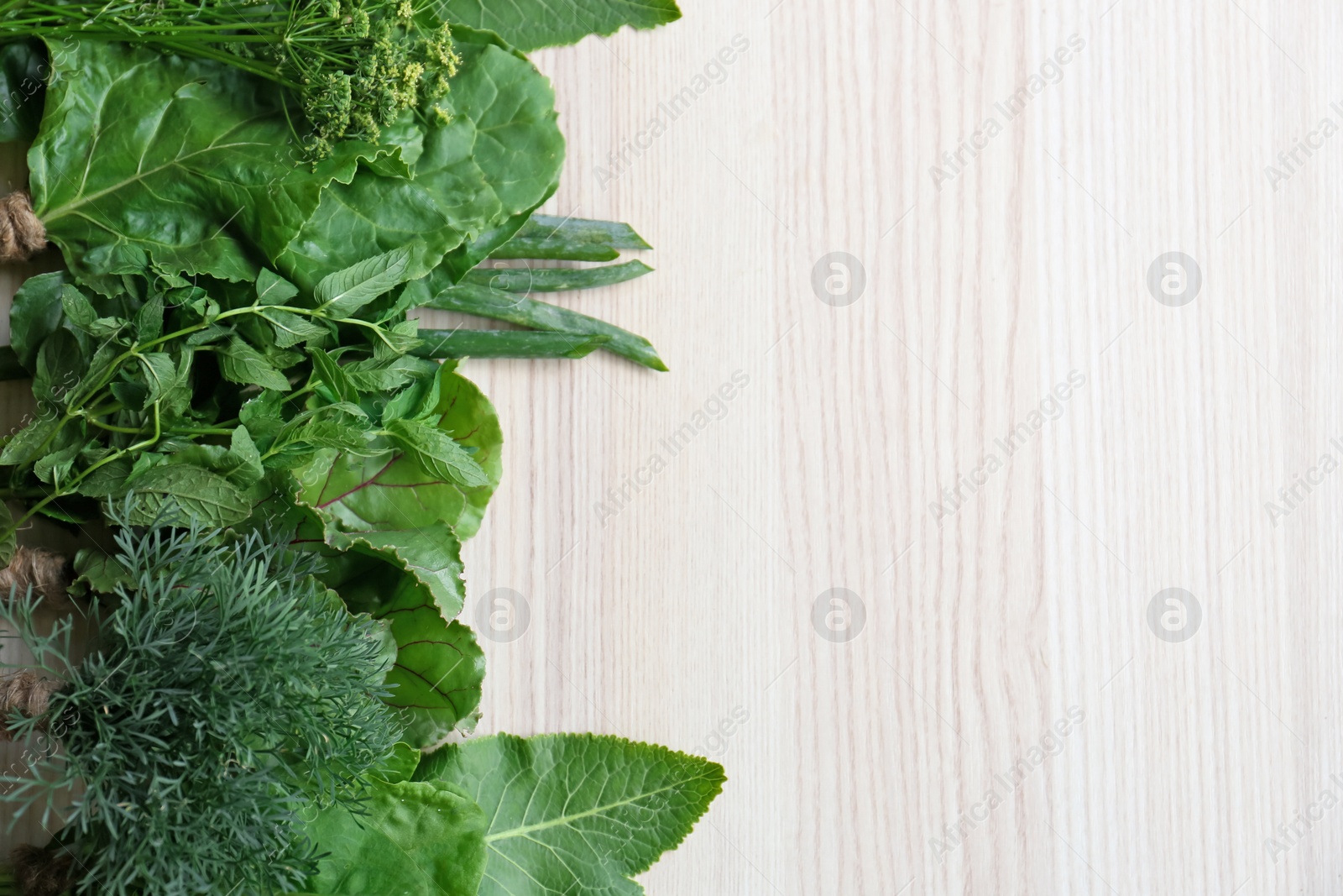 Photo of Different herbs on white wooden table, flat lay. Space for text