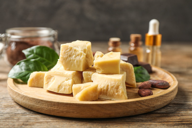 Composition with organic cocoa butter on wooden table