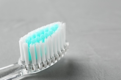 Photo of Manual toothbrush on gray background, close up