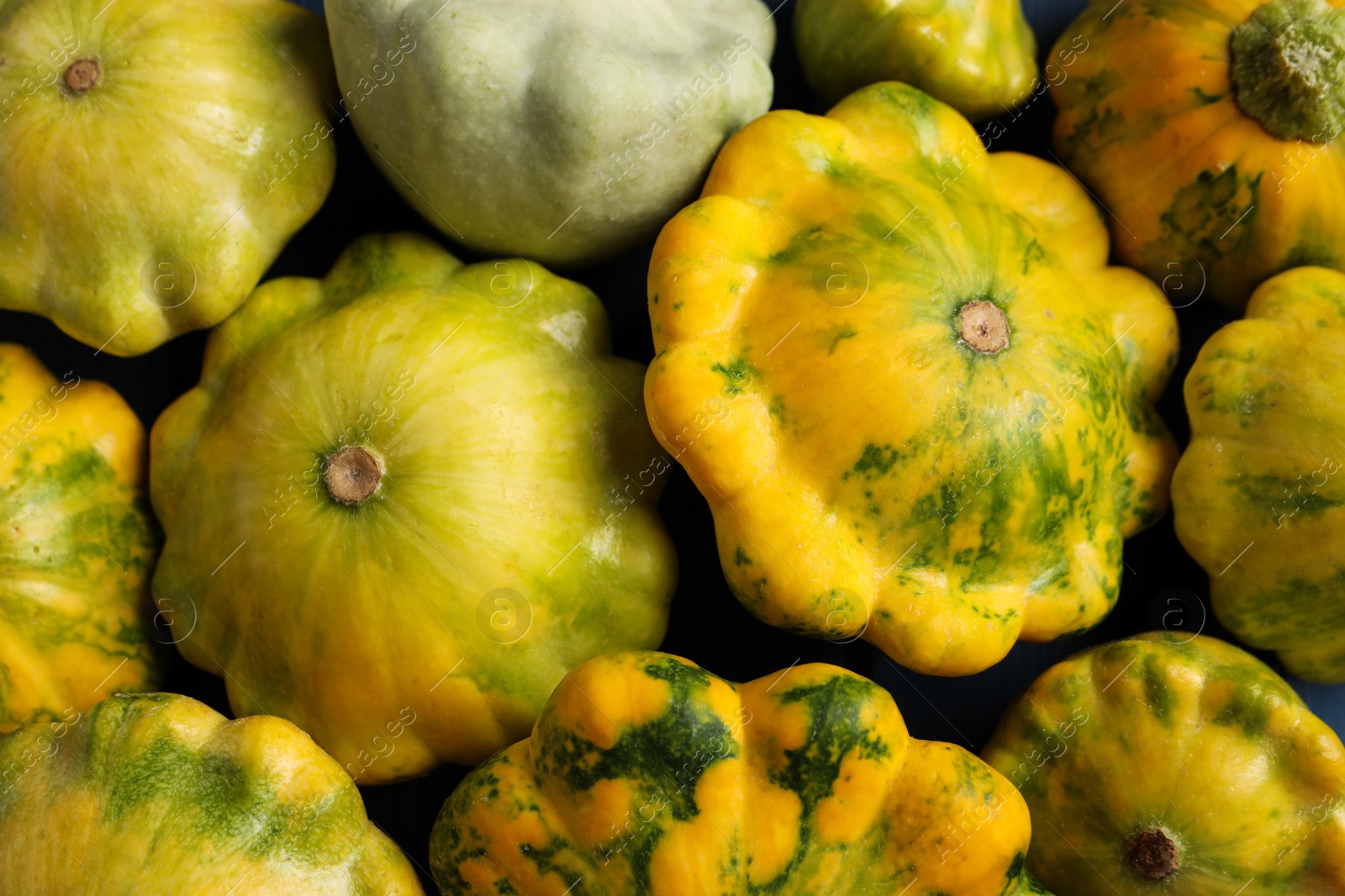 Photo of Fresh ripe pattypan squashes as background, top view