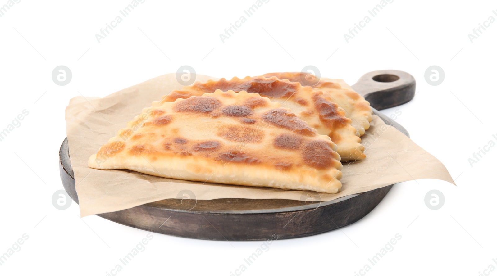 Photo of Wooden board with delicious fried chebureki isolated on white