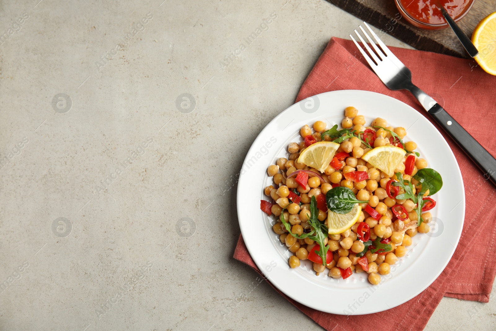 Photo of Delicious fresh chickpea salad on light grey table, flat lay. Space for text