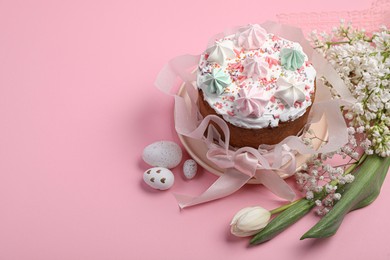 Photo of Traditional Easter cake with meringues and painted eggs on pink background, space for text