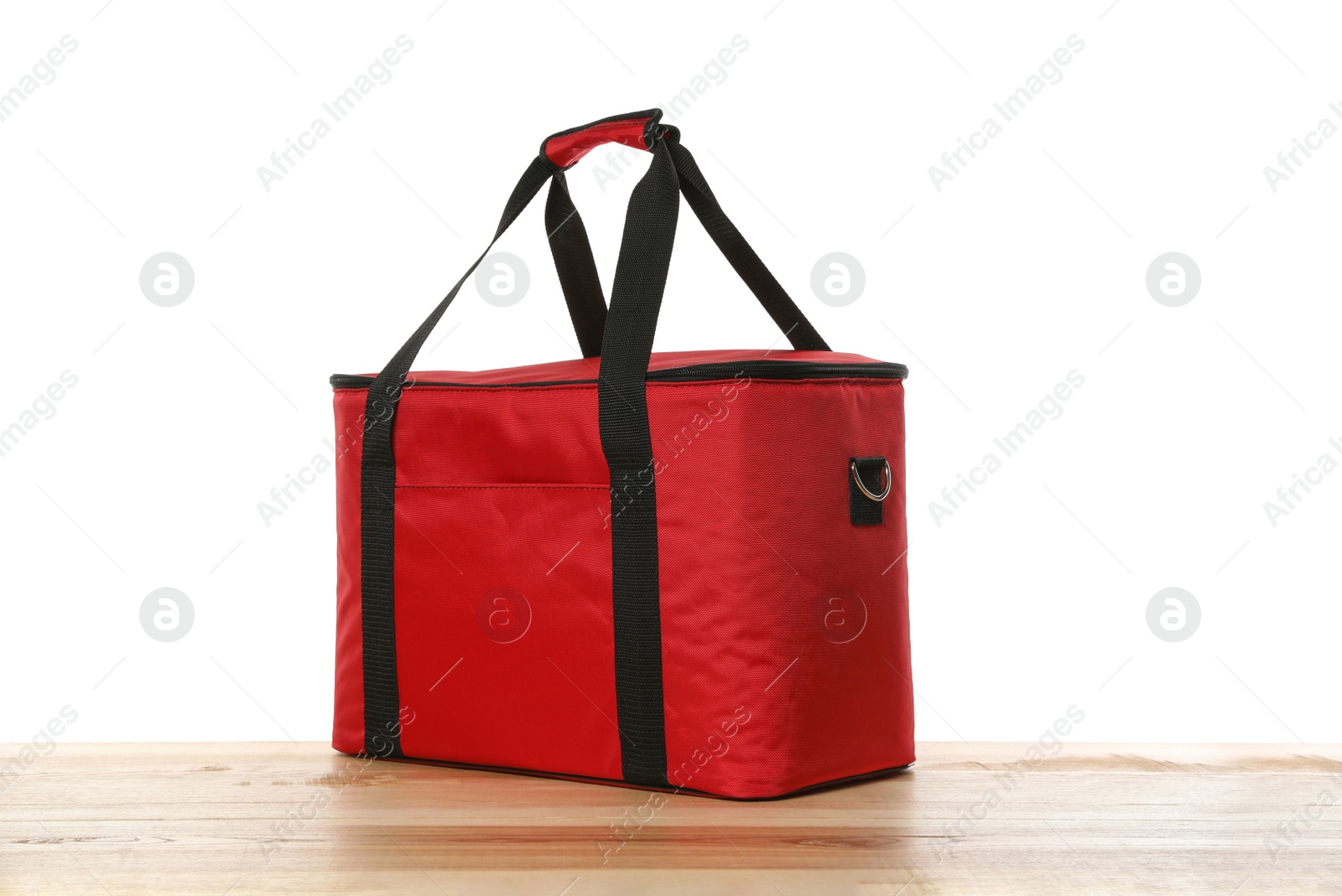 Photo of Modern red thermo bag on wooden table against white background