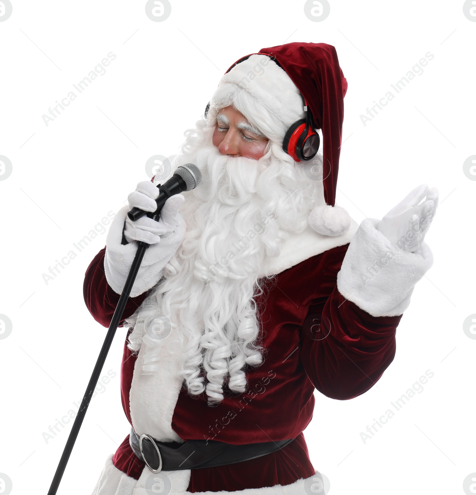 Photo of Santa Claus with headphones and microphone on white background. Christmas music