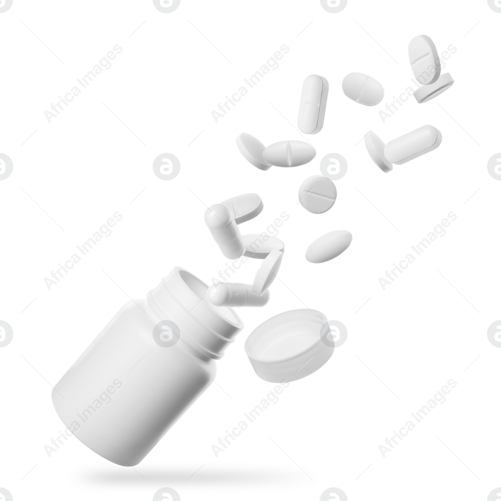 Image of Many different pills falling into bottle on white background