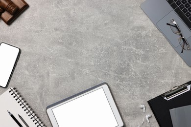 Photo of Flat lay composition with modern tablet on light gray textured table. Space for text