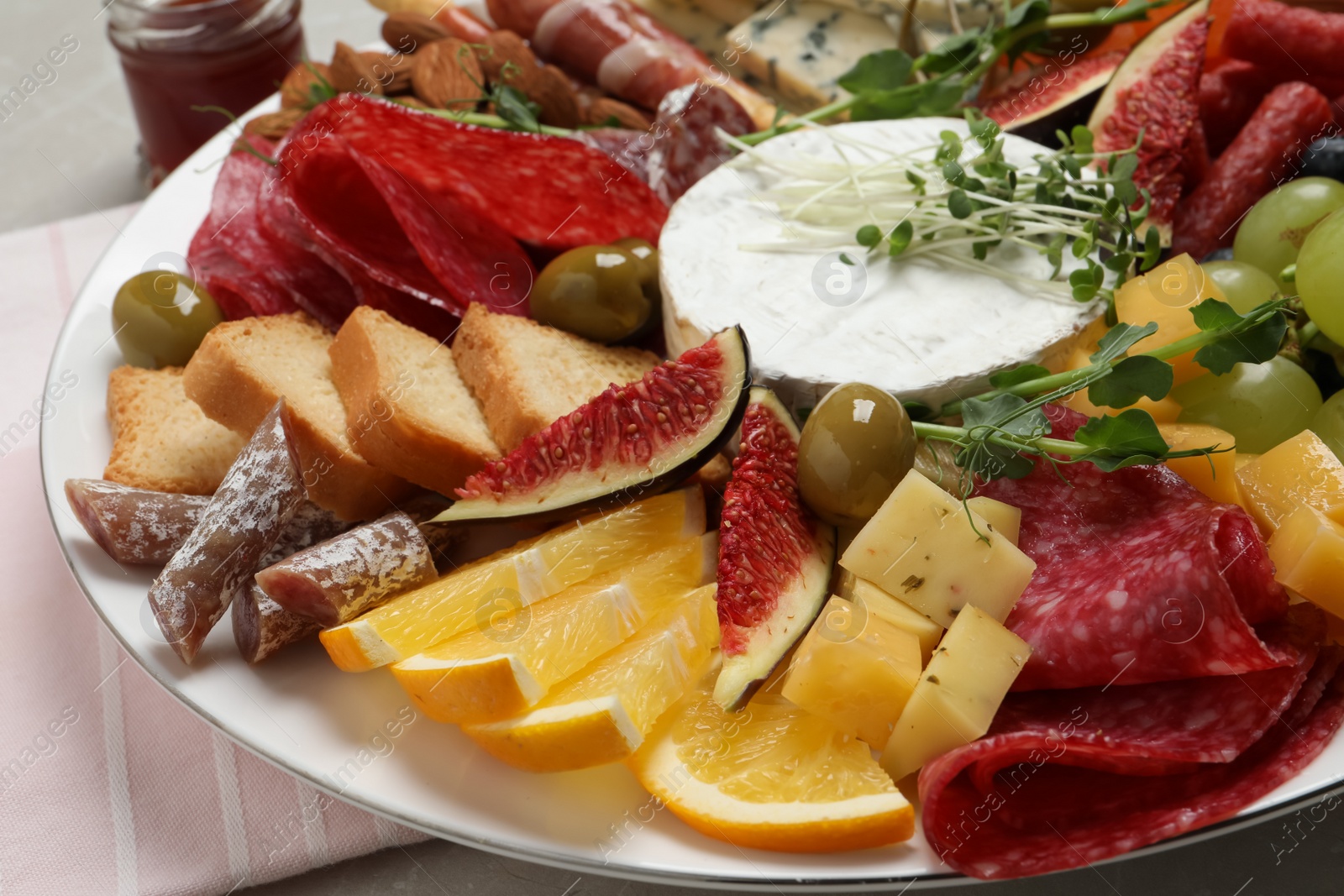 Photo of Set of different delicious appetizers on plate, closeup