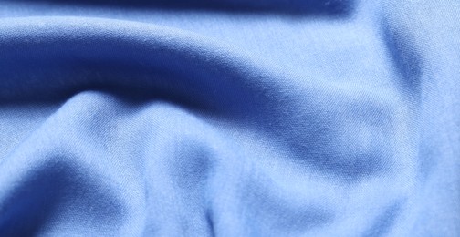 Texture of light blue crumpled fabric as background, closeup