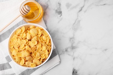 Photo of Breakfast cereal. Tasty crispy corn flakes in bowl and honey on white marble table, flat lay. Space for text