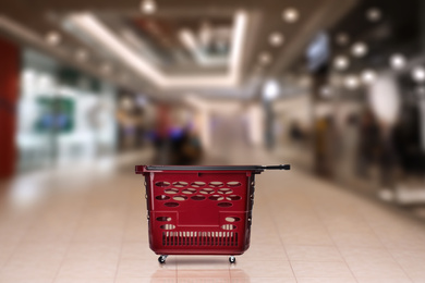 Image of Empty plastic red shopping basket in mall