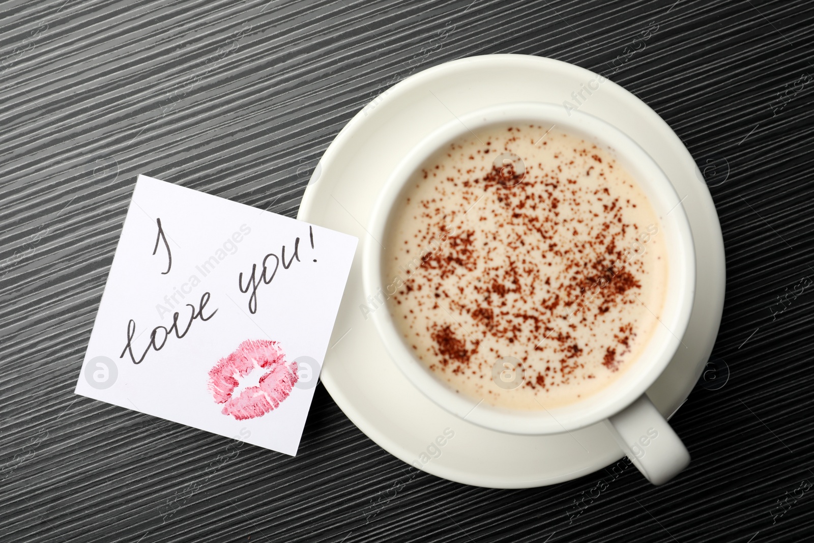 Photo of Paper with words I Love You and coffee on black wooden table, flat lay