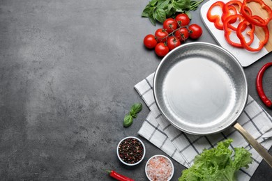 Photo of Flat lay composition with frying pan and fresh products on grey table, space for text