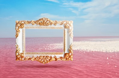 Vintage frame and beautiful pink lake under blue sky with clouds