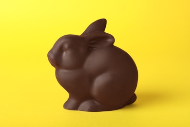 Photo of Chocolate bunny on yellow background. Easter celebration