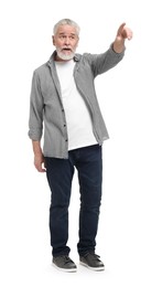 Senior man pointing at something on white background