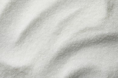 Photo of White granulated sugar as background, top view