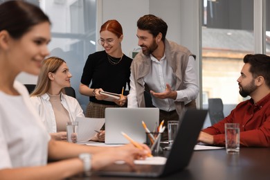 Team of employees working together in office