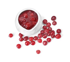 Photo of Cranberry sauce in pitcher and fresh berries isolated on white, top view