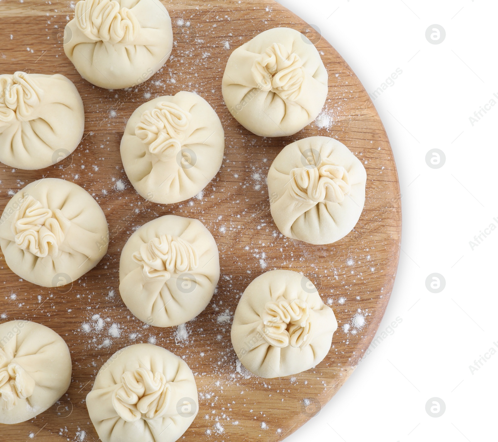 Photo of Board with uncooked khinkali (dumplings) isolated on white, top view. Georgian cuisine