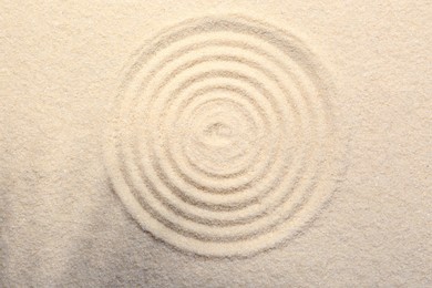 Zen rock garden. Circle pattern on beige sand, top view