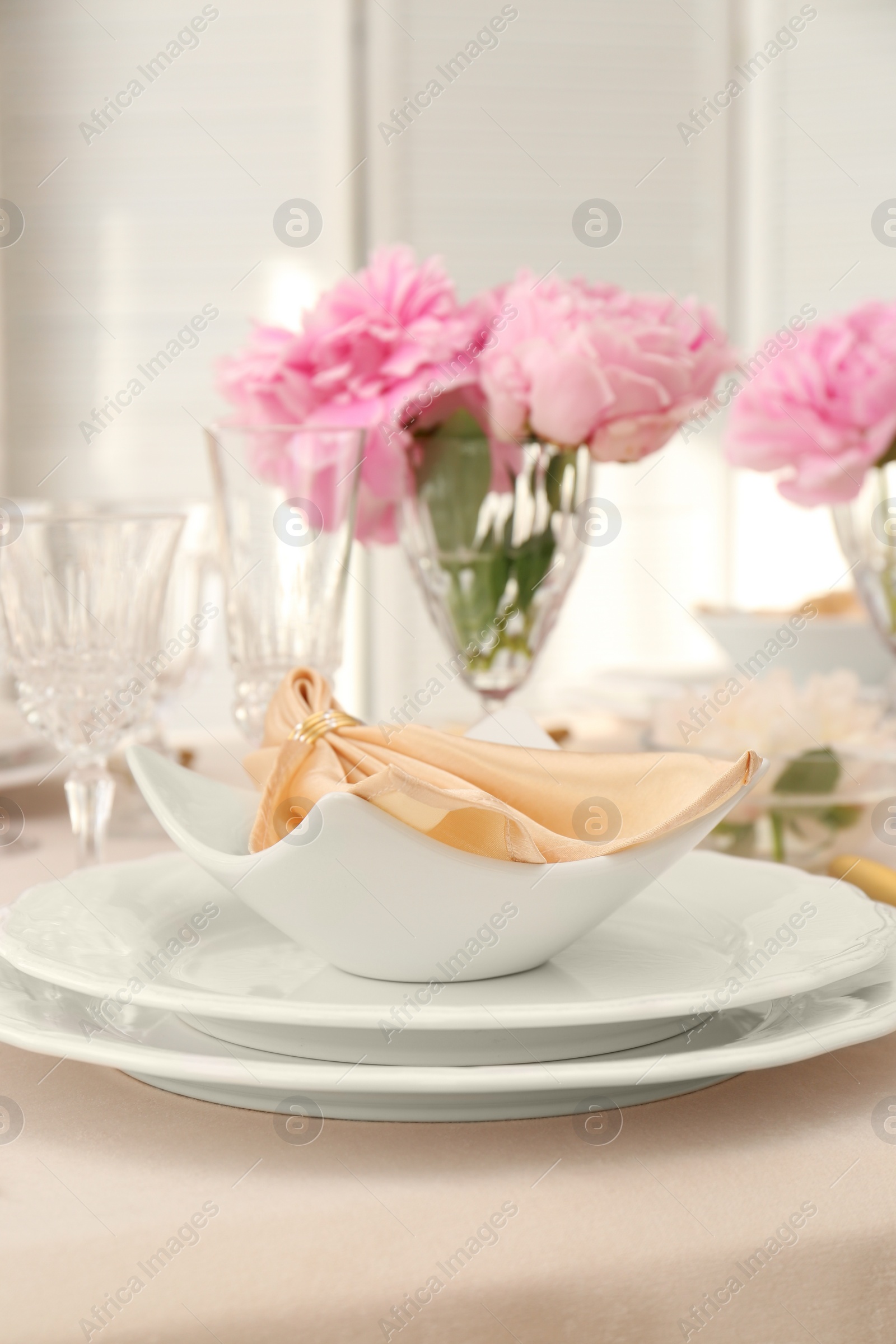 Photo of Stylish table setting with beautiful peonies and fabric napkin indoors