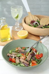 Photo of Delicious salad with beef tongue, vegetables and fork on white table