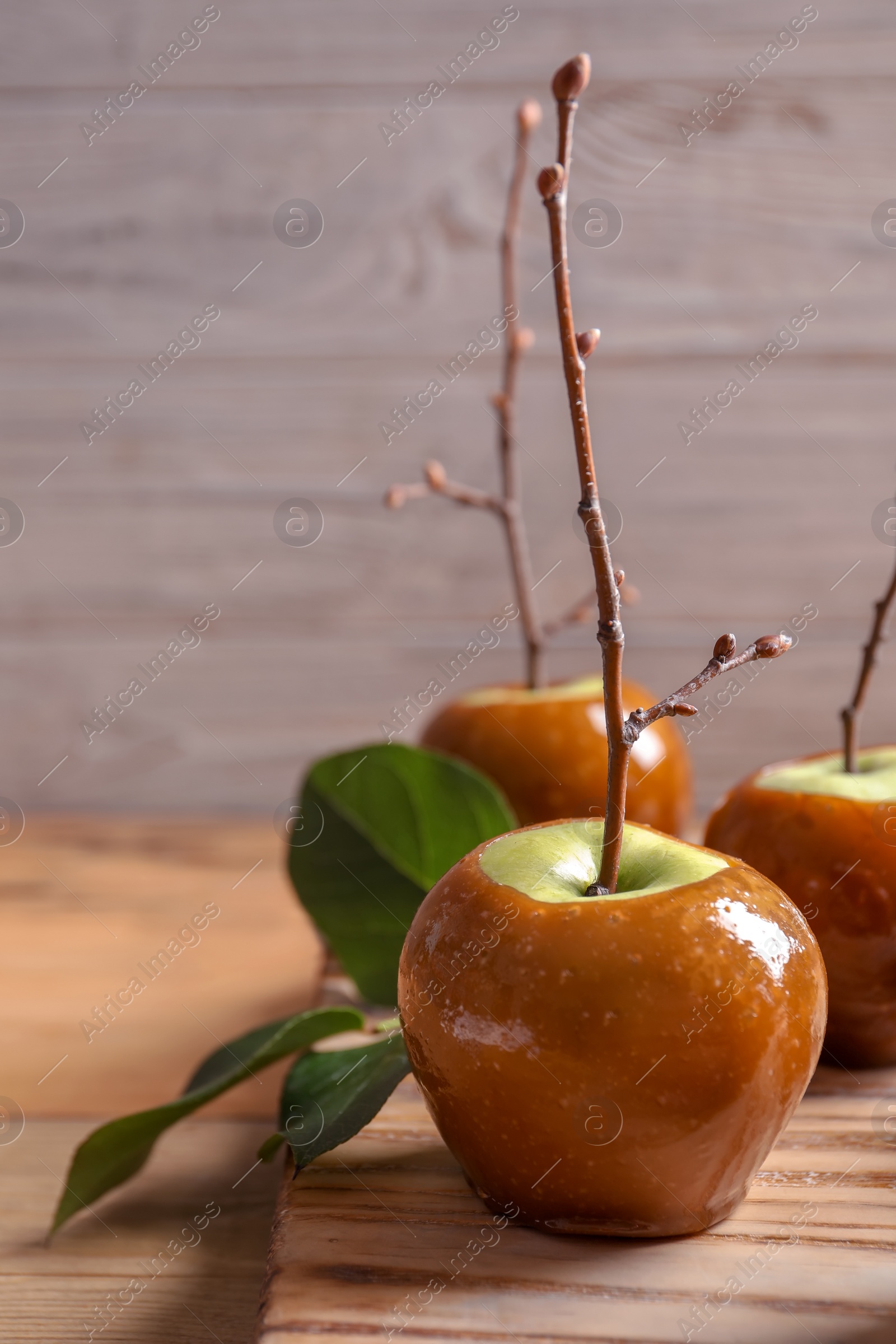 Photo of Delicious green caramel apples on table