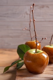 Photo of Delicious green caramel apples on table