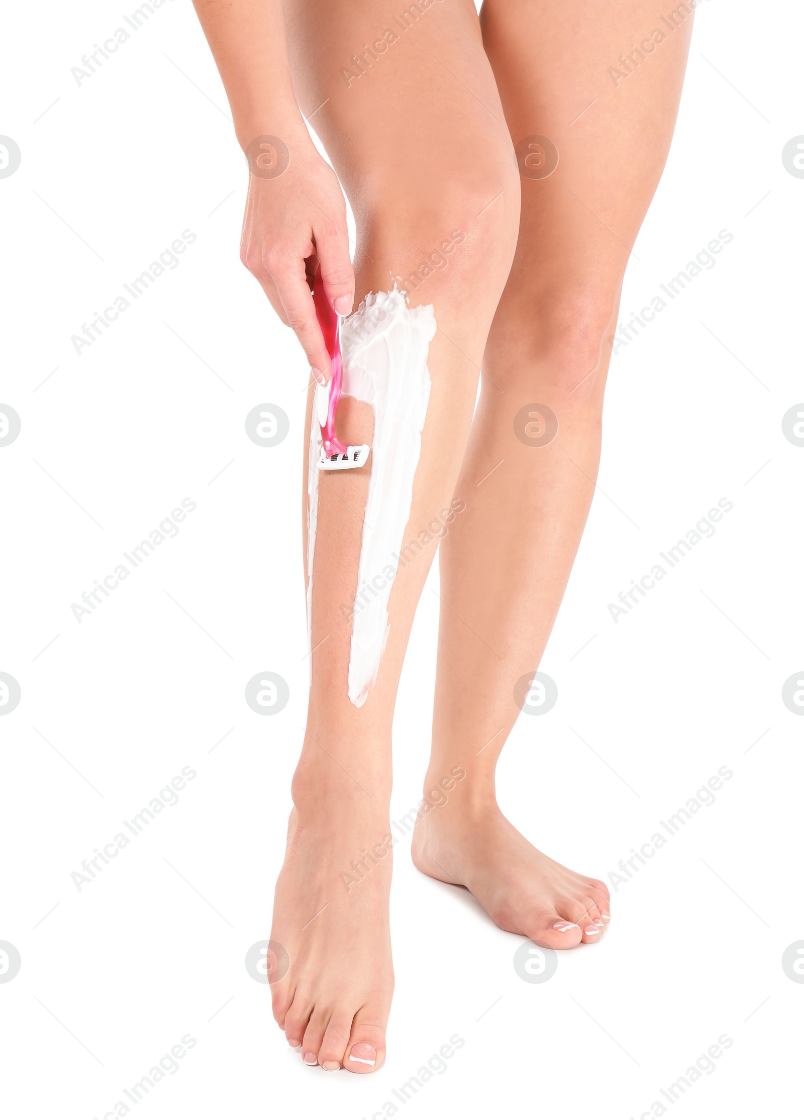 Photo of Beautiful young woman shaving leg on white background, closeup view