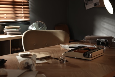 Photo of Detective workplace with vintage typewriter and documents