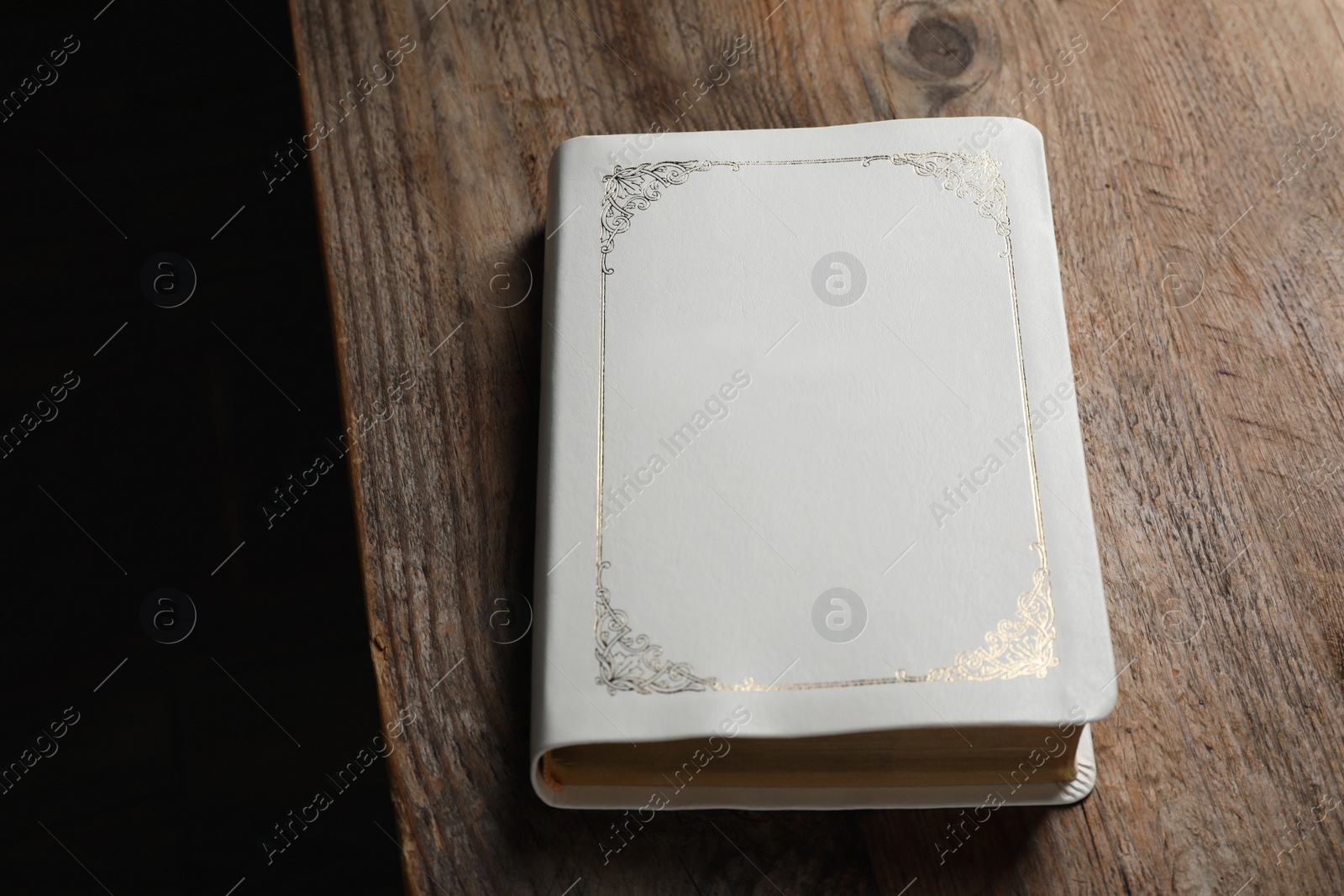 Photo of Bible on wooden table. Christian religious book