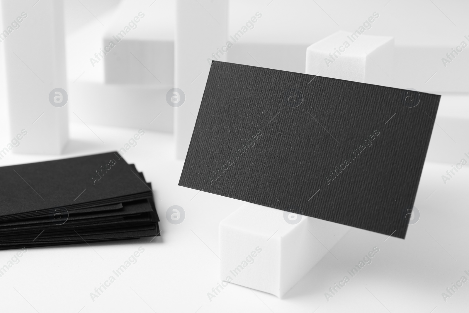 Photo of Blank black business cards on white background. Mockup for design