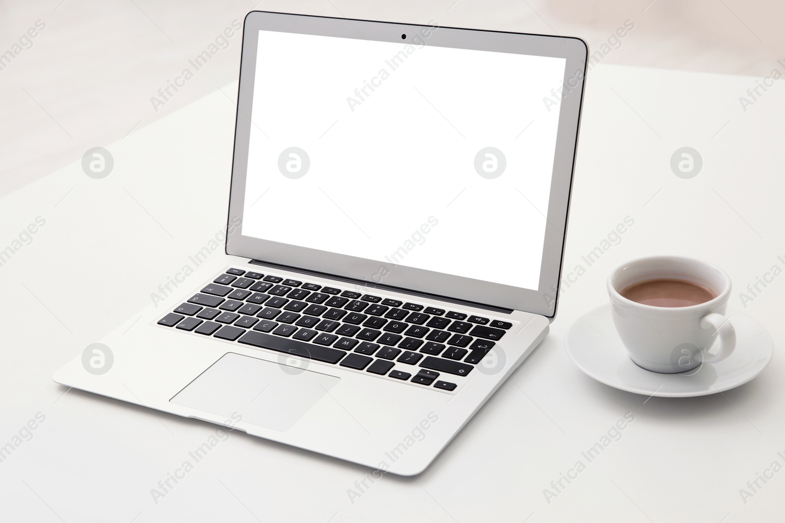 Photo of Comfortable workplace with modern laptop on table. Mockup for design