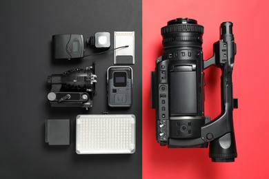 Photo of Flat lay composition with camera and video production equipment on color background