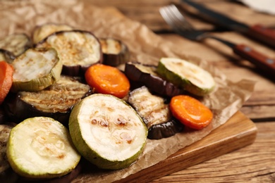 Photo of Delicious grilled vegetables served on wooden table, closeup
