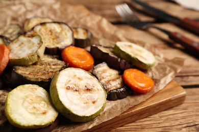 Delicious grilled vegetables served on wooden table, closeup