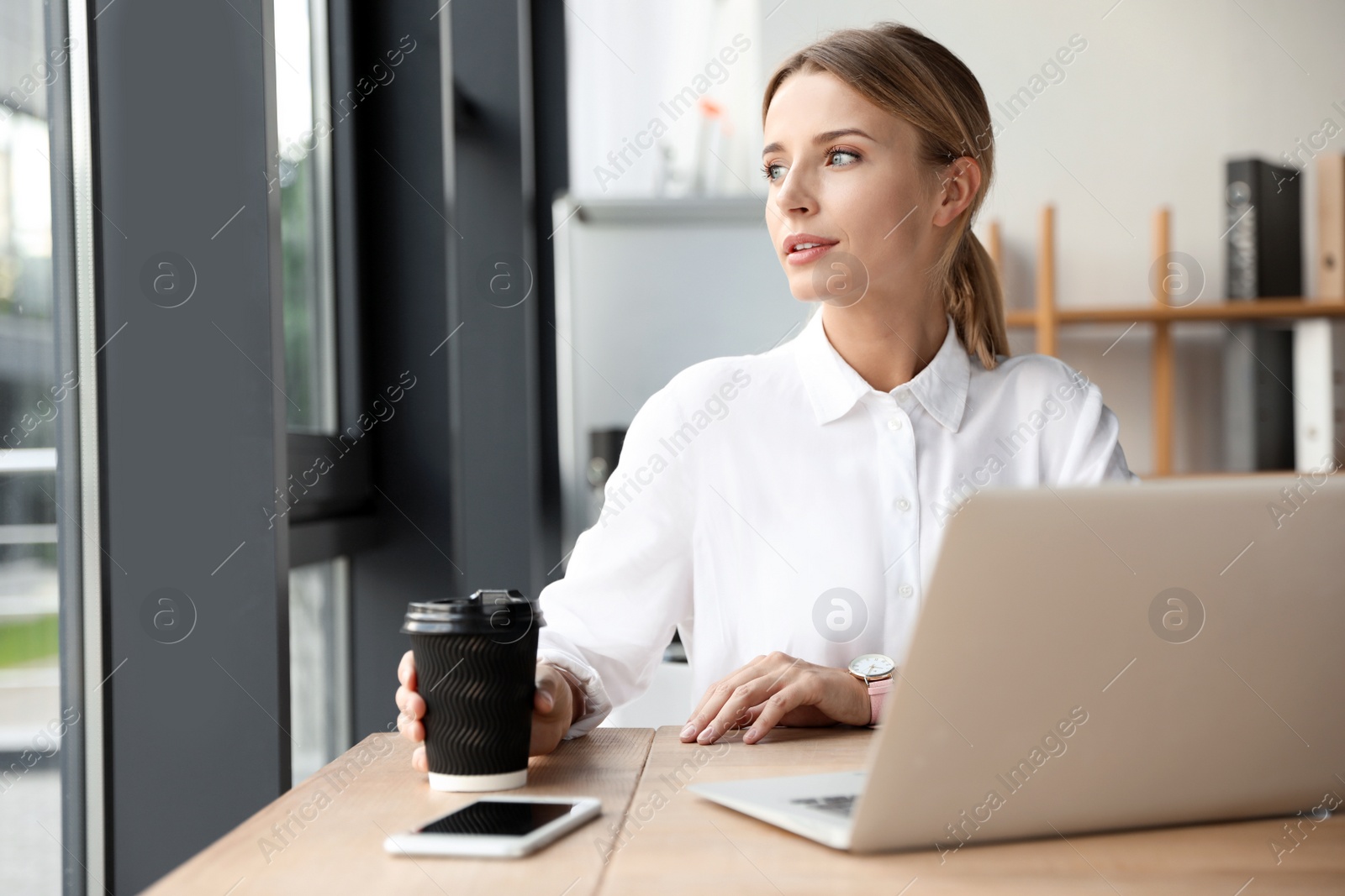 Photo of Female business trainer working with laptop in office